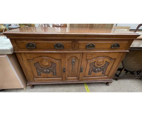 A 20th century oak sideboard, the rectangular top above two drawers and two cupboards on bracket feet together with a modern 