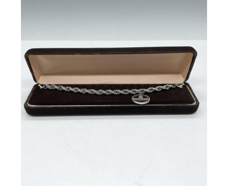 Lovely, braided metal with one charm for Palm Beach. This item has its original box: 8.25"L x 2.5"W x 1.75"H. Issued: 21st ce