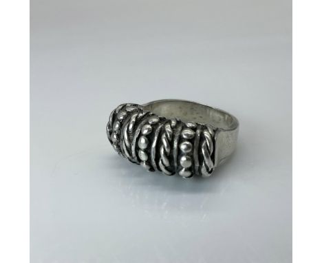 This silver ring has a woven or braided motif. Marked Mexico 925. Total weight 16 grams. The ring measures approximately 8.25