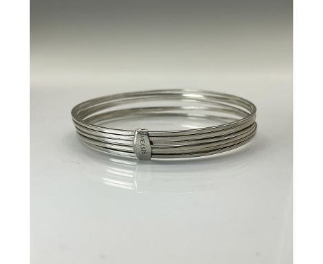This bracelet is constructed from 7 smaller silver bangle type bracelets, tired together with a silver keeper. Total weight 2