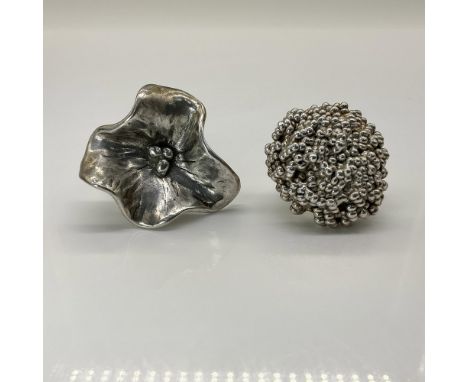 This unique pair includes a silver plated flower ring from Spain and a sterling silver ring featuring tiny balls in a large c