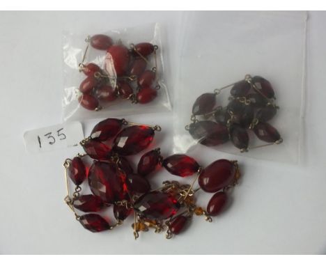 Four vintage necklaces, two with cherry bakelite  amber two with red faceted amber style beads     