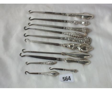Nine various silver handled button hooks    
