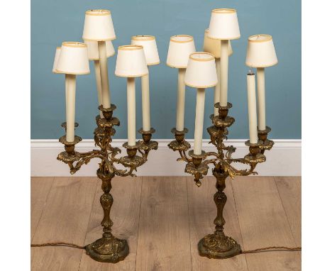 A pair of Rococo style continental gilt metal candelabra style lamp holders, with five branches each, 87cm high x 35cm wide (