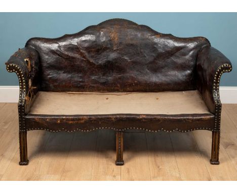 A brown leather camelback sofa, with brass stud detail, on carved oak legs, 155cm wide x 74cm deep x 91cm highUsed and worn c