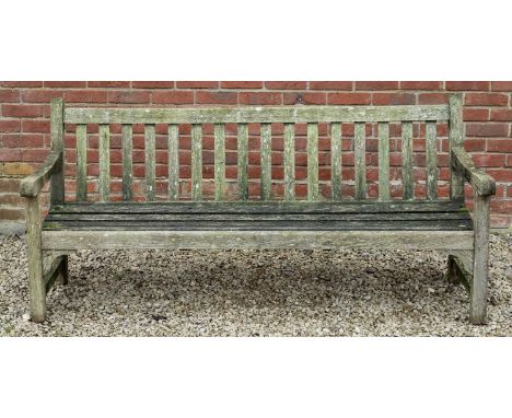 A teak garden bench with slatted back and seat, 183cm wide x 68cm deep x 84cm highWeathered condition overall. Some slight mo