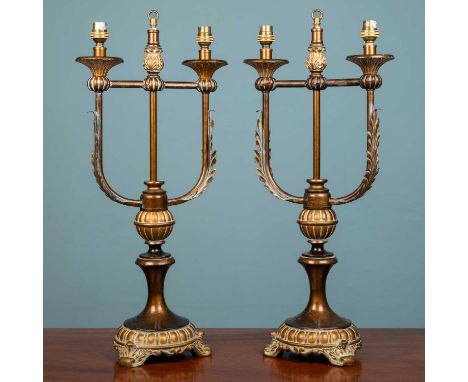 A pair of continental Empire style lamp stands, carved and painted wood and brass, with a bronzed effect, 61cm high x 30cm wi