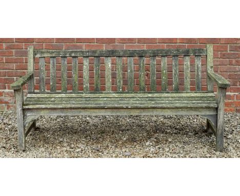 A teak garden bench with flat arms, with a label for 'Lister', 187cm wide x 67cm deep x 87cm highWeathered condition overall.