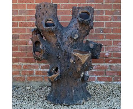 A Victorian stoneware faux tree trunk planter, 105cm high x 80cm wideA large section of loss to one side, further chips and l