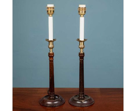 A pair of Georgian style wooden fluted 'candlestick' lampstands on circular wooden bases, with brass floral and foliate detai
