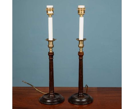 A pair of Georgian style wooden fluted 'candlestick' lampstands on circular wooden bases, with brass floral and foliate desig