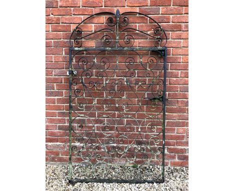 A black painted wrought iron single gate, with scrolling ornament, 57cm wide x 172cm high