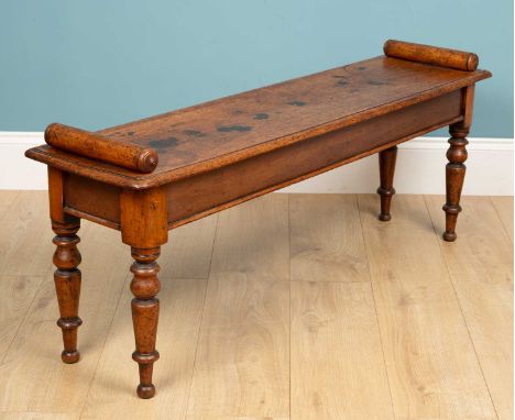 A mid-Victorian mahogany hall bench or window seat, with a rectangular top and cylindrical ends all on turned tapering legs, 