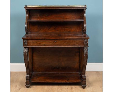 A George IV rosewood chiffonier, The upper section with brass gallery and shelf, above a freeze drawer and carved scrolling s