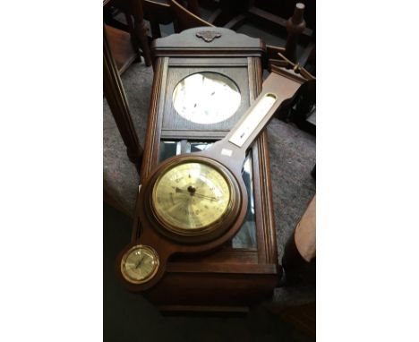 An oak cased wall clock, with pendulum and key, 76cmH; together with a West German banjo barometer, 71cmH 