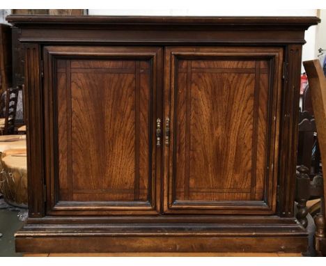 A small cupboard, two panelled doors on plinth base, with single glass shelf, bears plaque for Brandt of Hagerstown, Maryland