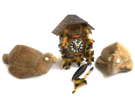 Two carved wooden turtles with mother of pearl inlaid eyes; together with a cuckoo clock 