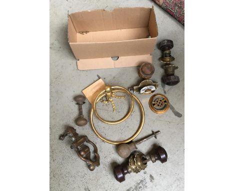 A brass double loop towel holder; a vintage brass and enamel Ashwell's Patent WC bolt 'engaged' and 'vacant'; brass door knoc