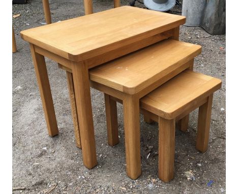 A nest of three light oak tables, the largest 60x38x50cmH 