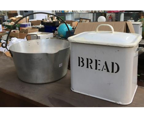 A white enamel bread bin with twin handles, 30cmW; together with an aluminium saucepan with swing handle, 35cmD 