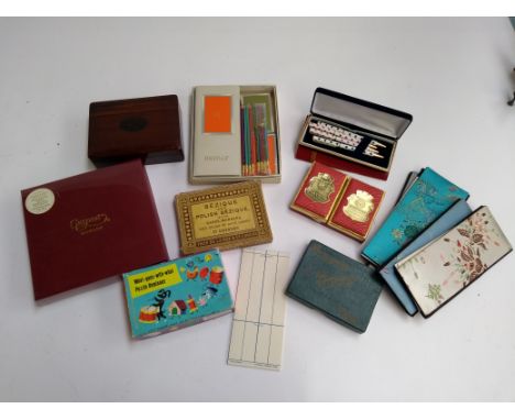 A mixed box of playing cards and games to include Bezique, bidge sets, pens, etc