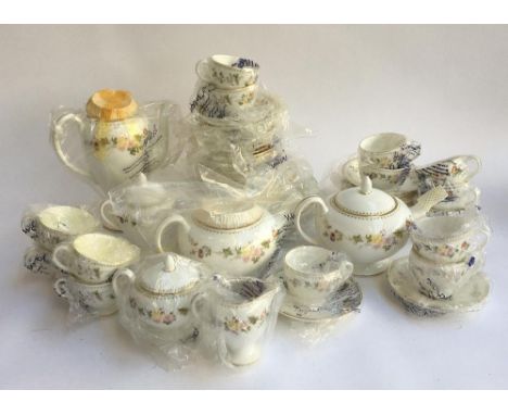 A Wedgwood 'Mirabelle' tea service, mostly new in original wrapping, to include cups, saucers, teapot, coffee pot, sideplates