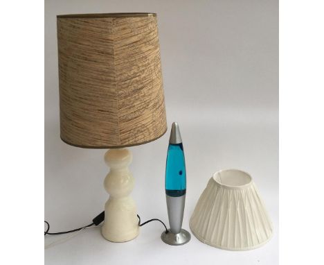A 1970s ceramic table lamp with shade, 76cmH; together with a blue lava lamp and one other lampshade 