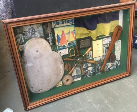 A mahogany framed glazed 'shadow box', on a maritime theme, containing various memorabilia, cleats, shackle, pulleys, compass