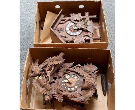 Two Wall Hanging Cuckoo Clocks, of typical form with heavily carved leaf foliage and bird detail (2)with pendulums and weight