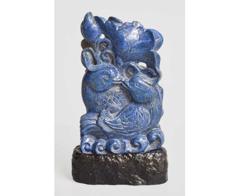 A Chinese Carved Lapis Lazuli Group, comprising two entwined birds within flowers and foliage, on carved wooden base, total h