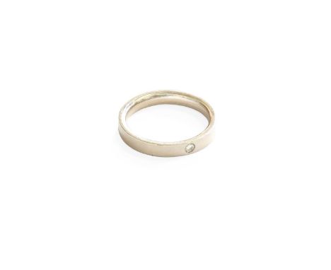 A Platinum Band Ring, inset with a single round brilliant cut diamond, finger size L1/2Gross weight 5.9 grams.