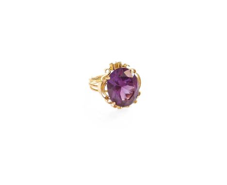 A Synthetic Sapphire Simulating Alexandrite Ring, the oval cut synthetic sapphire simulating alexandrite in a yellow claw set