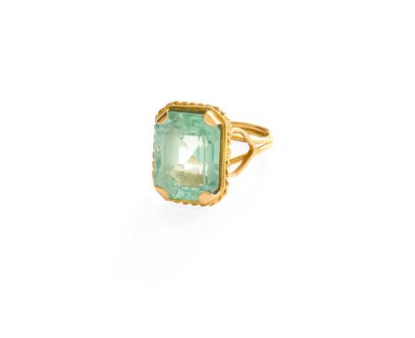 A Synthetic Green Spinel Ring, the emerald-cut synthetic green spinel in a yellow claw setting, within a rope twist border, t