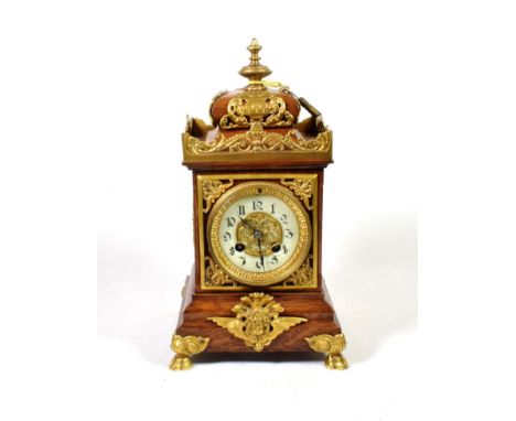An oak and gilt metal mounted striking mantel clock, circa 1910, twin barrel movement striking on a gong