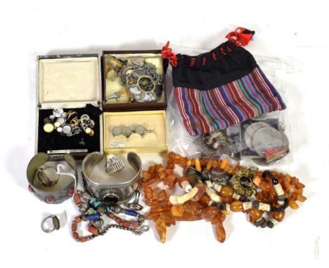 A quantity of costume jewellery including Victorian shirt buttons; a bangle stamped '925'; unmarked rings; an amber necklace;
