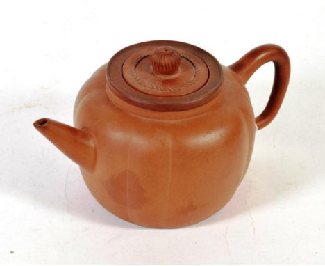 A Chinese Yixing redware teapot, melon fluted, with cover and strainer