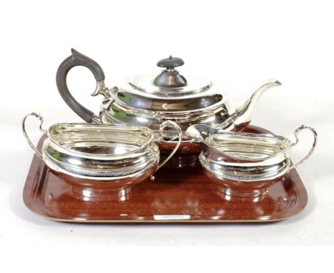 A three piece silver tea service, Viners Ltd, Sheffield 1952/55, oval, with a band of engraved decoration, the teapot 28cm lo