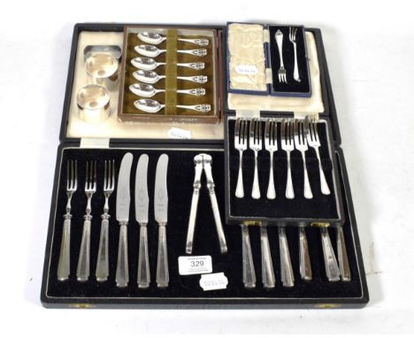 Cased silver flatware including six pairs of fruit knives and forks, six cake forks, six tea spoons, three napkin rings and t