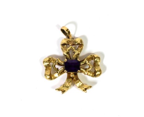 An amethyst set bow motif, later adapted as a pendant, with locket panel to the reverse, measures 5.8cm by 4.5cm.  Gross weig