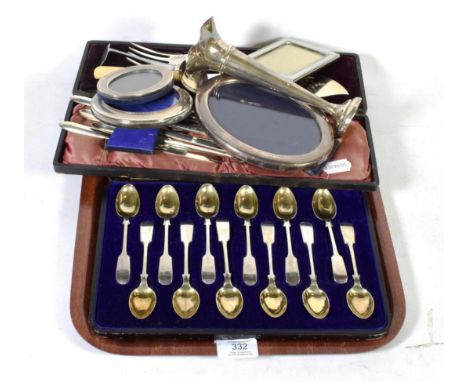 A set of twelve silver fiddle pattern teaspoons, Henry Williamson, Sheffield 1910, in a fitted case; three silver photograph 