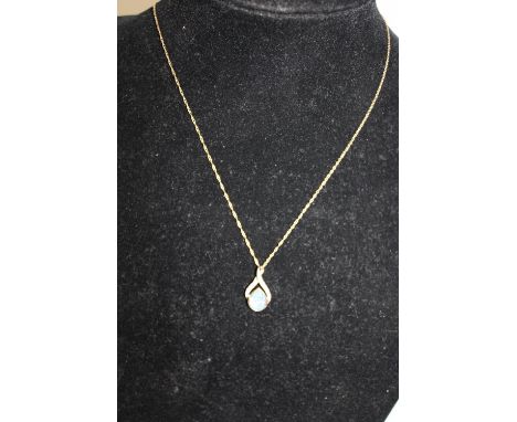 A diamond &amp; opal pendant on a 9ct gold chain 