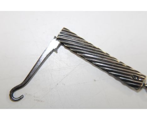 A small silver handled button hook 