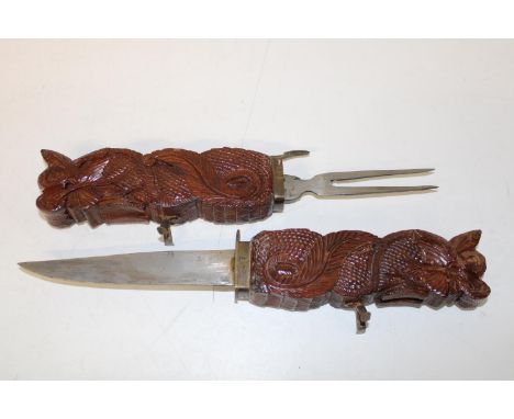 A carved wooden knife &amp; fork set 
