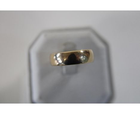 A large 9ct gold band ring. Size V 6.2 grams 