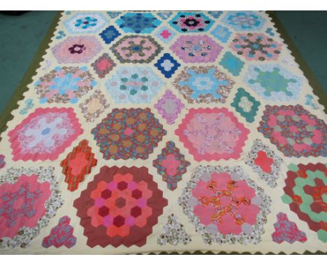 A hexagonal multi pattern patch work quilt made from 1950s, 60s. 70s fabrics, 250cm x 230cm 