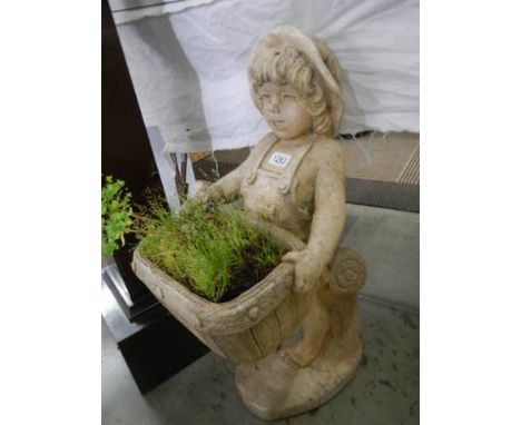 An old garden statue of a girl holding a trough of plants. COLLECT ONLY. 
