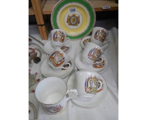 Six commemorative cups and saucers and a commemorative plate. 