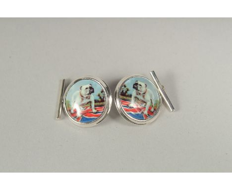 A pair of silver bulldog cufflinks in a box.