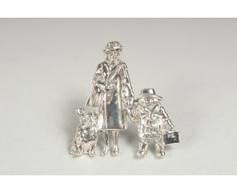 A silver brooch Queen Elizabeth II, Paddington Bear and corgi in a box.