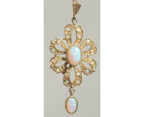 A silver gold plated opal pendant and chain in a box.